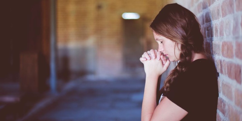girl hands clasped prayer